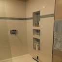 Custom Designed, Built and Tiled Shower Insets to match Cabinet Shelf Design