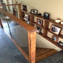Custom Designed and Built Glass Handrail and Built-in Wall Shelving
